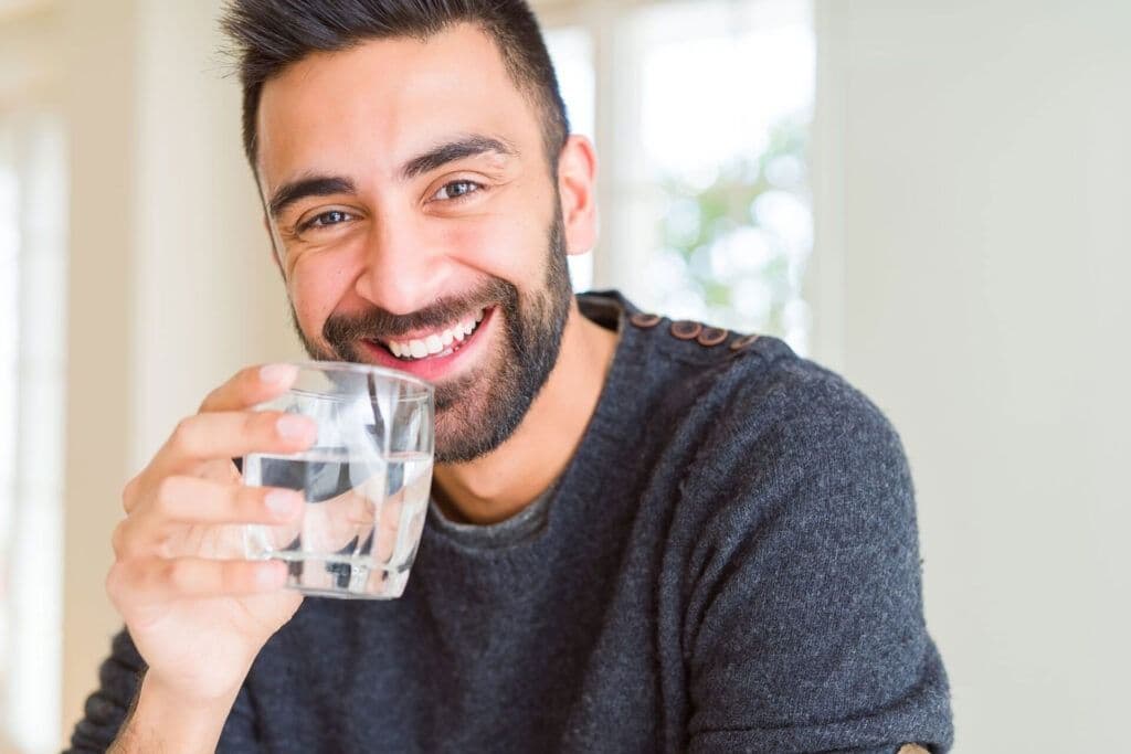 man drinking a fresh glass of water