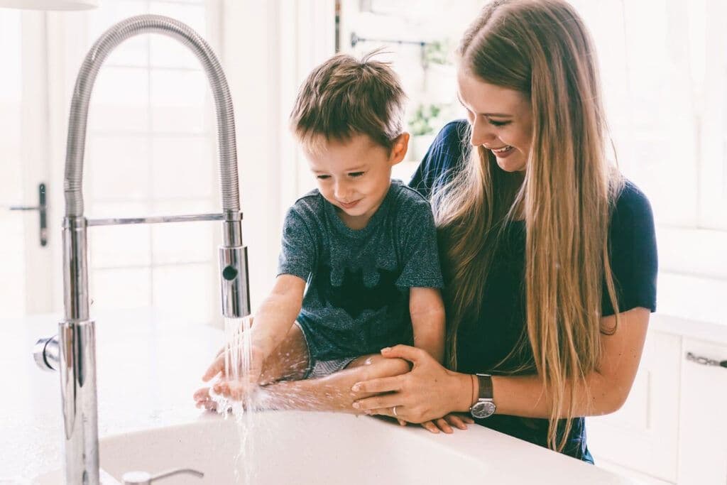 mother with her child playing sink